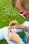 Girl making a daisy chain