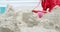 Girl making making sand castle at beach