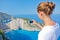 Girl making photo with Navagio bay and Ship Wreck beach in summer. The famous natural landmark of Zakynthos, Greek