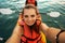 Girl making selfie on sunset kayaking at sea