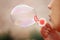 Girl making soap bubbles, close-up