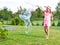 Girl making soap bubbles in home garden