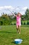 Girl making soap bubbles in home garden