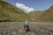 Girl and man riding a horse in a valley of the Great Caucasus, Azerbaijan. Riding the brown horse in a path in the hills. Green