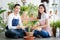 Girl man sit on floor smiling helping growth Hahnii tee togetherness in white room. Air filtering plants for houseplant. Eco