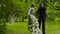 Girl and man on stilts dancing in the park