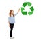Girl with marker pointing to green recycle symbol
