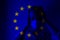 Girl in a mask against the background of the EU flag. Fear of illness, corona virus 2019-2020. Virus, outbreak and mass disease,