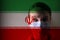 Girl in a mask against the background of the Iran flag; danger of disease, new virus