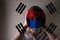 Girl in a mask against the background of the South Korea flag; danger of disease, new virus