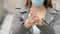 Girl with mask cleaning hands with alcohol sanitiser