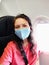 A girl in a mask makes a selfie in the cabin of the plane. flights under the new rules coronavirus