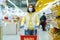 Girl in mask standing at grocery store with shopping cart during covid pandemic