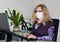 Girl in mask working at office