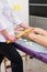 Girl massage therapist does anti-cellulite massage to a girl on a massage table in a spa salon with a bamboo stick. Spa treatments