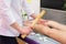 Girl massage therapist does anti-cellulite massage to a girl on a massage table in a spa salon with a bamboo stick. Spa treatments