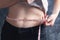 Girl measures belly with a centimeter