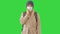 Girl in a medical face mask standing in a coat on a Green Screen, Chroma Key.