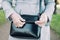 A girl in medical gloves opens a black leather bag