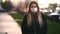 Girl in a medical mask on the background of the city. Coronavirus. Prevention of viral diseases