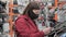 Girl in medical mask buys tablet pad in shop