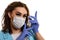 A girl in a medical mask, gloves and a robe on a white background. Beautician, beauty specialist.