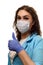 A girl in a medical mask, gloves and a robe on a white background. Beautician, beauty specialist. White-blue tones photo