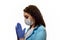 A girl in a medical mask, gloves and a robe on a white background. Beautician, beauty specialist. White-blue tones photo