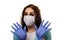 A girl in a medical mask, gloves and a robe on a white background. Beautician, beauty specialist. White-blue tones photo