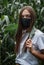 Girl in a medical mask in the jungle,