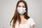 Girl in a medical mask long hair white T-shirt