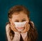 Girl in a medical mask with a painted smile