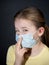 Girl in a medical protective mask. Coronavirus epidemic. Conceptual image. Stop the virus. Protective equipment