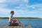 Girl meditates in nature by the lake on a nice sunny day