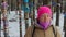 Girl meditates in the winter forest among the trees with colored ribbons