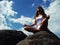 Girl meditating on a mountaintop