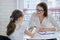 Girl at meeting with psychologist showing his social page on smartphone