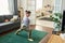 Girl with mental disability doing stretching exercise on the floor at home