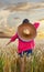 Girl, with mexican hat, in the cornfield