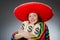 Girl in mexican vivid poncho holding money bags