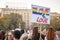 Girl in the middle of the crowd raising a sign saying `love is love` during the Belgrade Gay Pride.