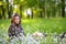 Girl in military uniform sits in a field on the grass