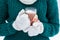 Girl mittens holding Christmas hot cocoa with melting marshmallows in glass cup