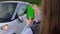 Girl with mobile green screen takes photo in parking. Car accident broken mirror