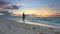 Girl with model walking strolling along coastline