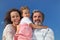 Girl, mother and grandfather smiling and embracing