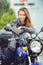 Girl in moto equipment with a motorcycle