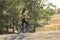 Girl on a mountain bike on offroad, beautiful portrait of a cyclist at sunset