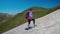 Girl mountaineer climbing snowy slope