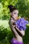 girl with naked back and fancy creative make-up holding iris flowers bouquet